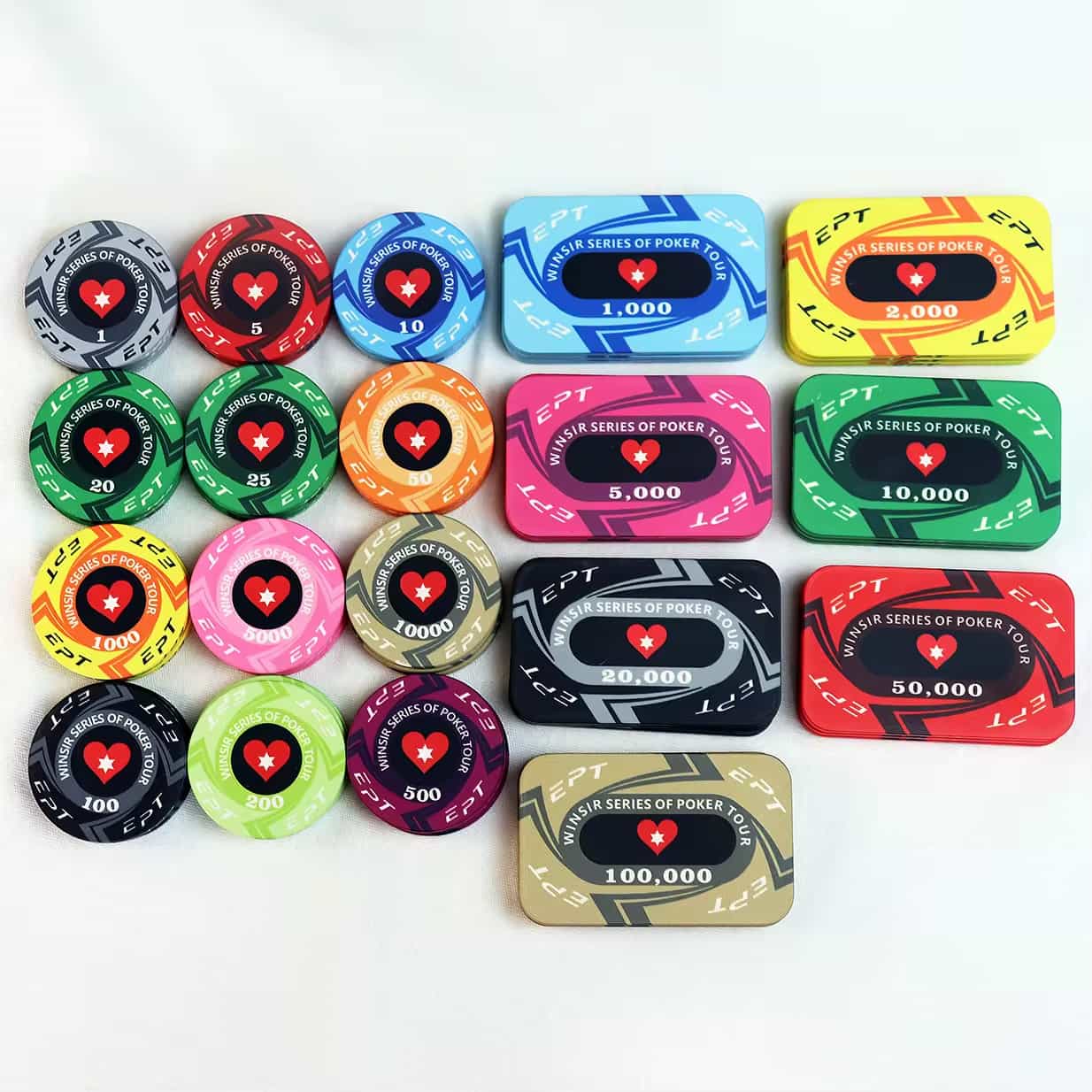 A collection of colorful poker chips and plaques from the "Winsir Series of Poker Tour" (EPT), with various denominations ranging from 1 to 100,000, arranged on a white surface.