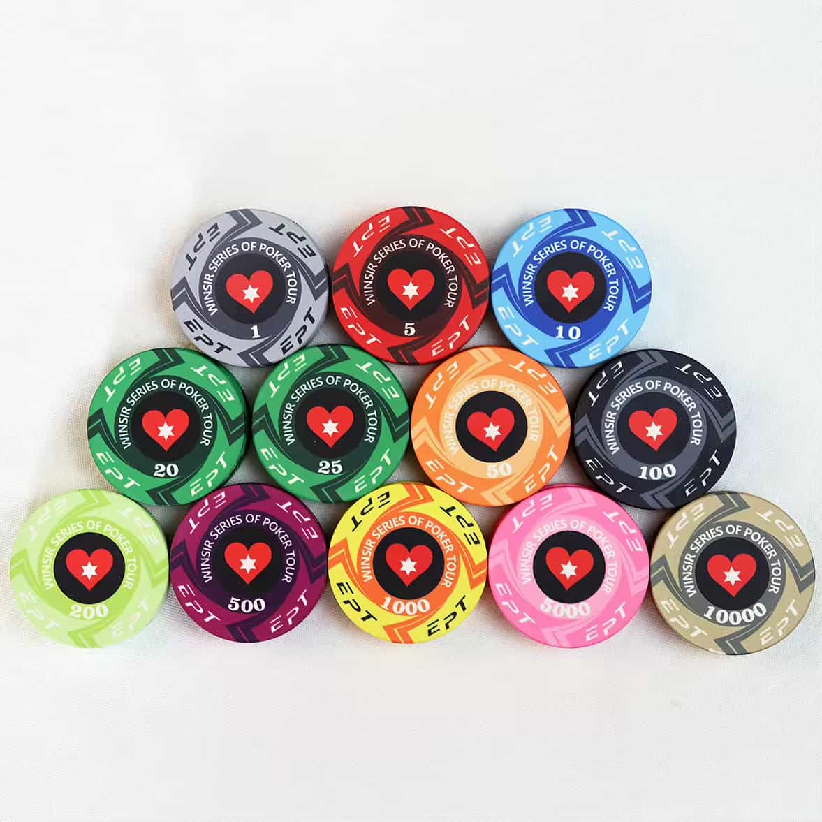 A collection of colorful poker chips from the "Winair Series of Poker Tour" (EPT), each with a distinct denomination, arranged in a triangular formation.