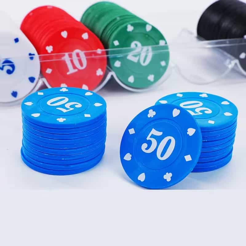 Stacks of colorful poker chips with denominations, including blue chips marked "50", red chips marked "10", green chips marked "20", and others, arranged on a white surface.
